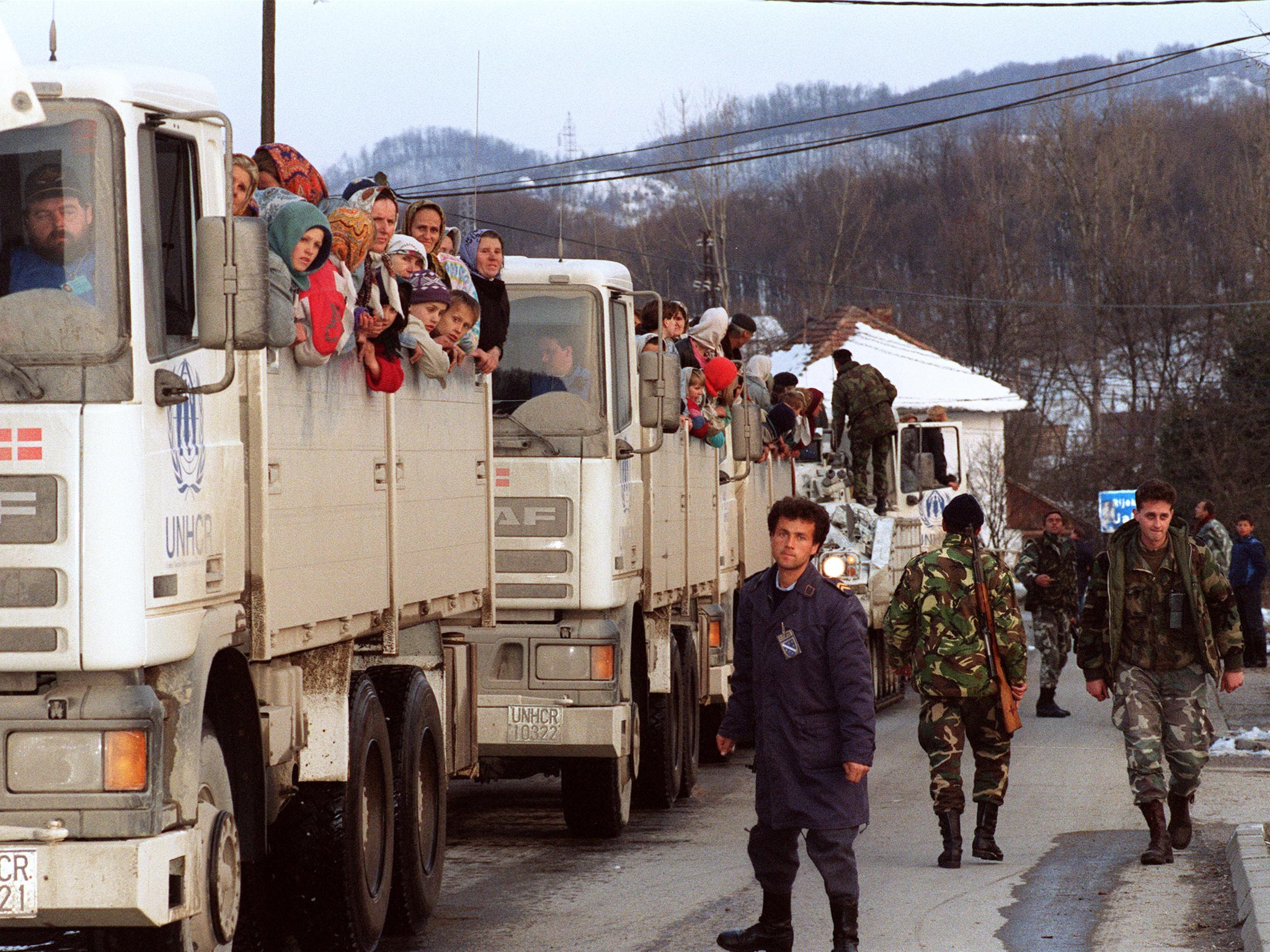 Muslim refugees ride United Nations vehicles in 1993, in a 19-truck convoy as they flee the Serb-besieged Bosnian enclave of Srebrenica for Tuzla