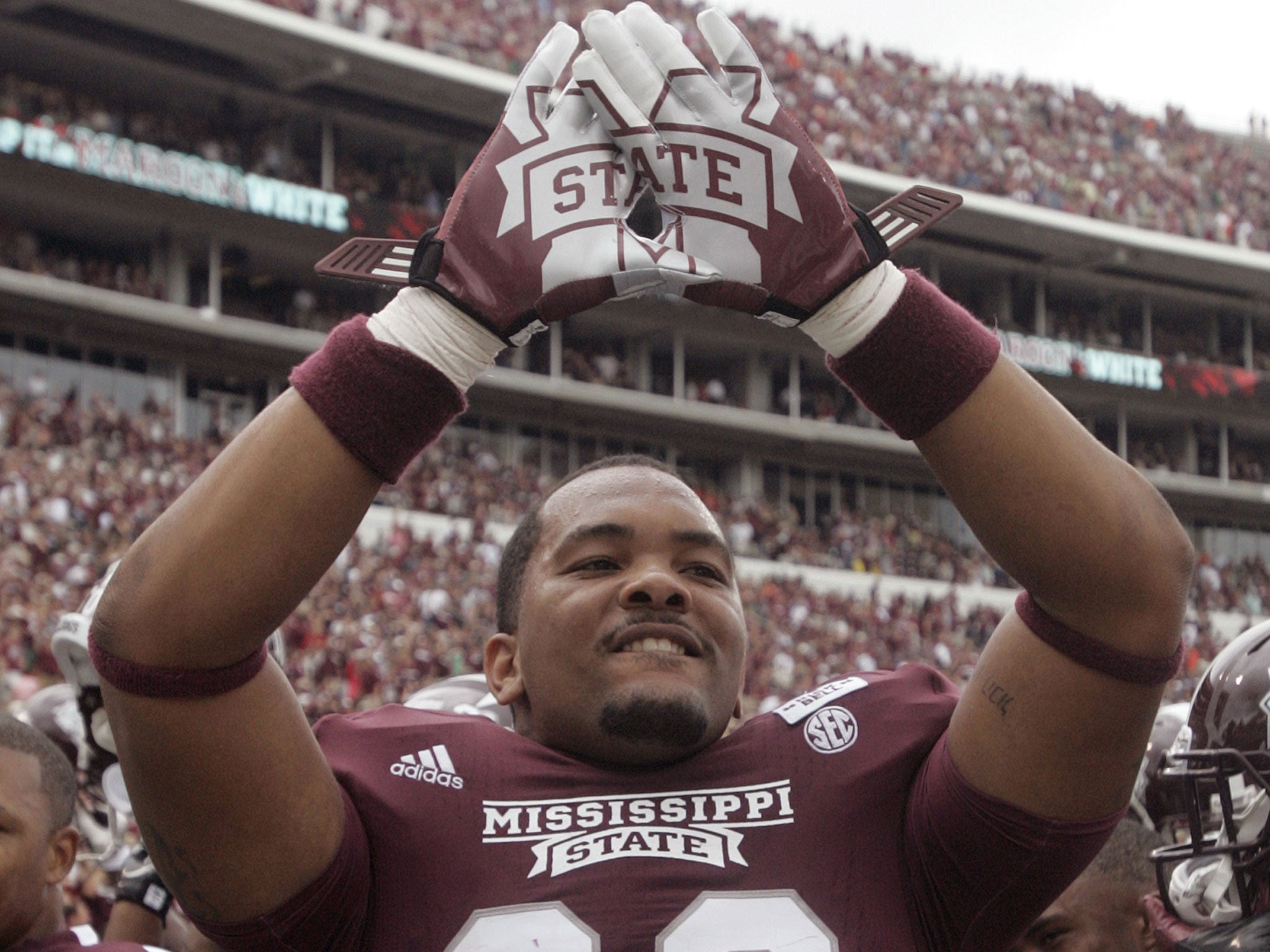Tight end Rufus Warren of the Mississippi State Bulldogs celebrates a win. He told NFL hopeful Michael Sam that he "looks down" on gay players after Mr Sam revealed he is gay.