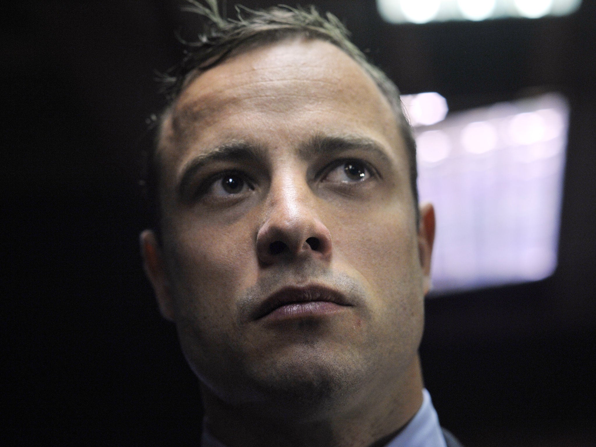 Oscar Pistorius stands in the Magistrate Court in Pretoria after appearing for the first time since being freed on bail over the Valentine's Day killing of his model girlfriend, 2013