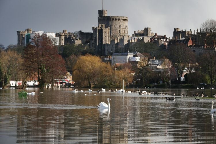 Windsor Castle towers above a swollen Thames, across from Eton, yesterday where the school’s weights room fell victim to flooding
