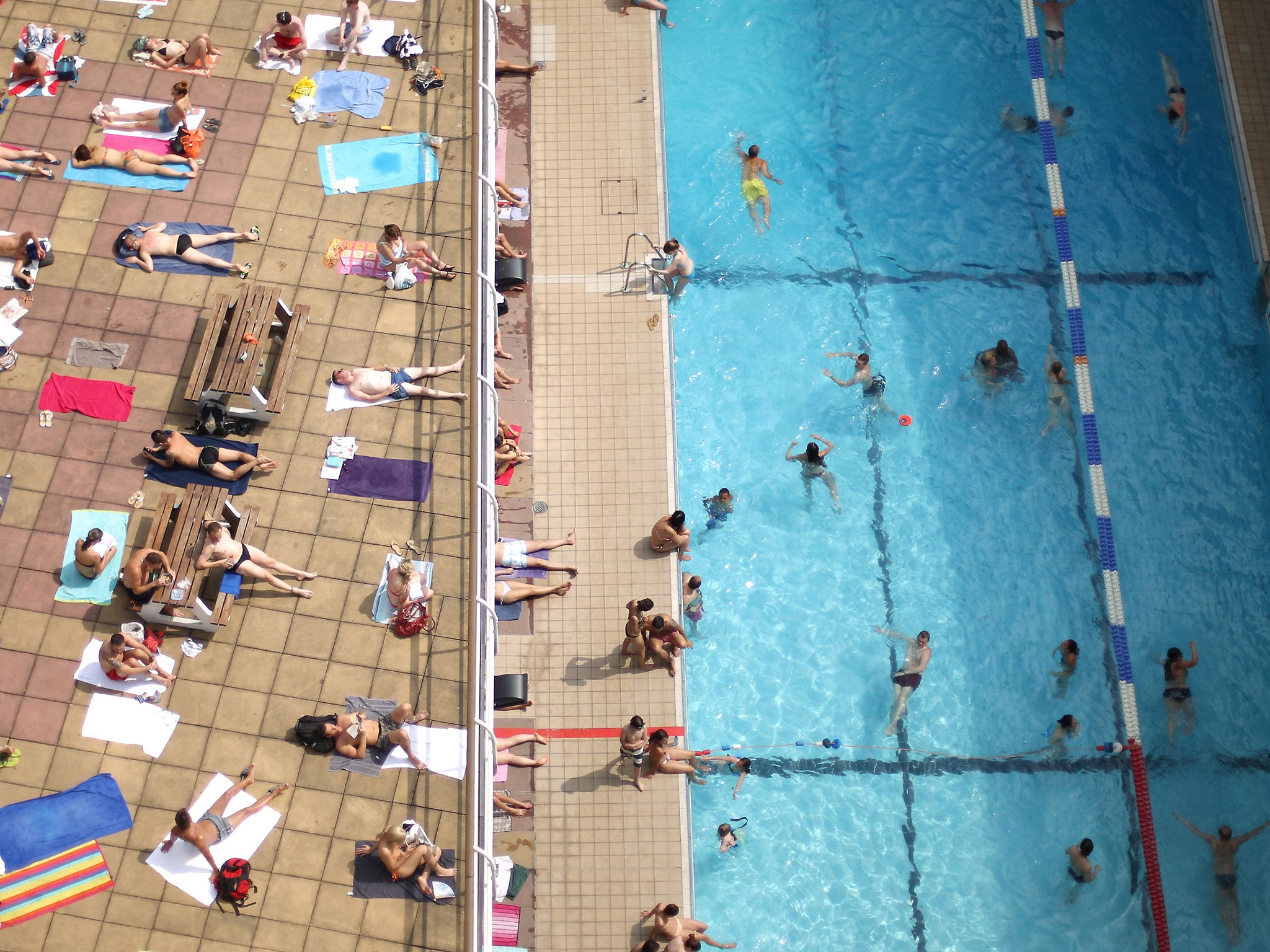Swimmers enjoy the sunshine at an outdoor pool in central London on July 17, 2013 in England. The United Kingdom is experiencing heatwave conditions for a second week.
