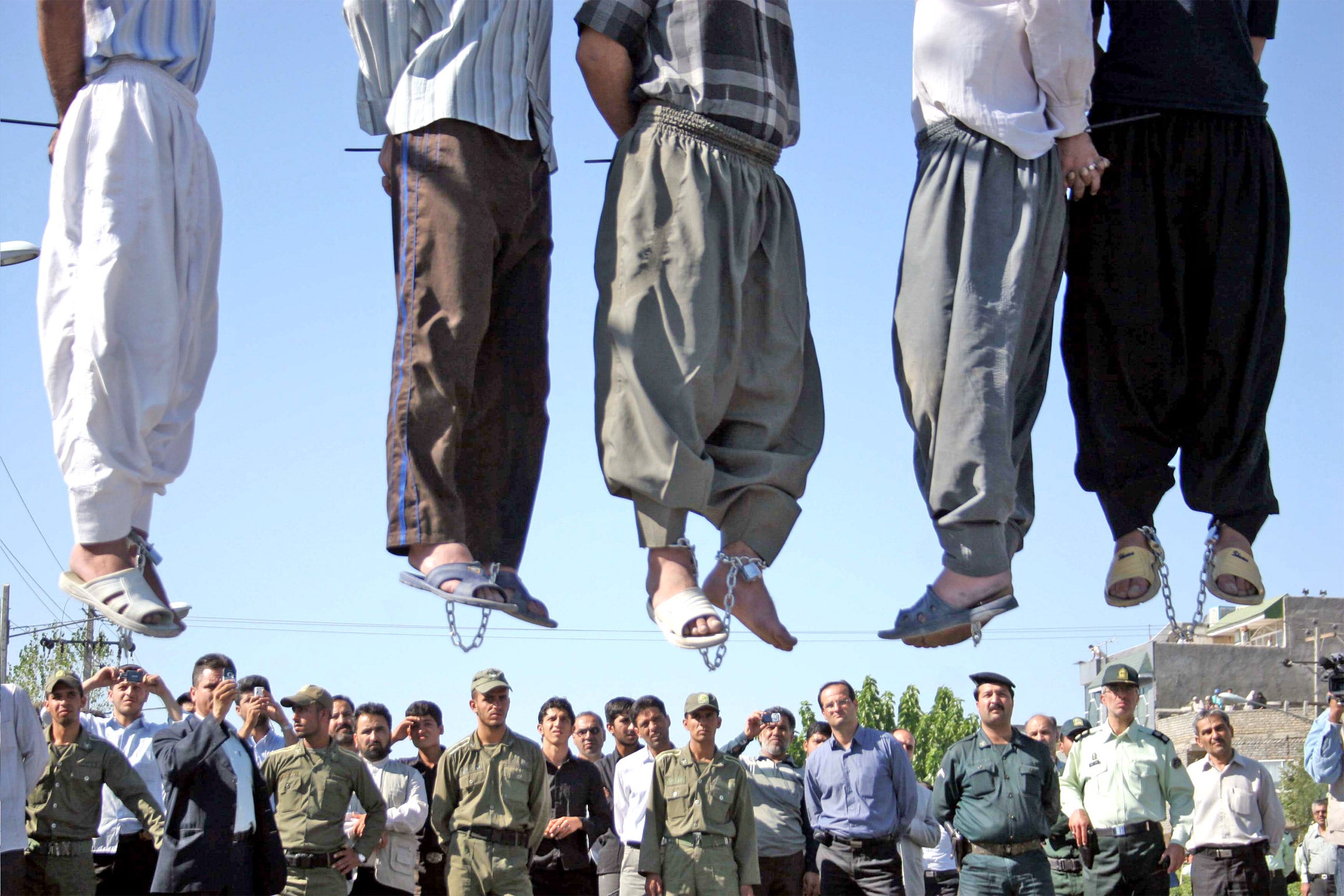 A public hanging north of Tehran, highlighting the lack of change in the Iranian government's approach to capital punishment.