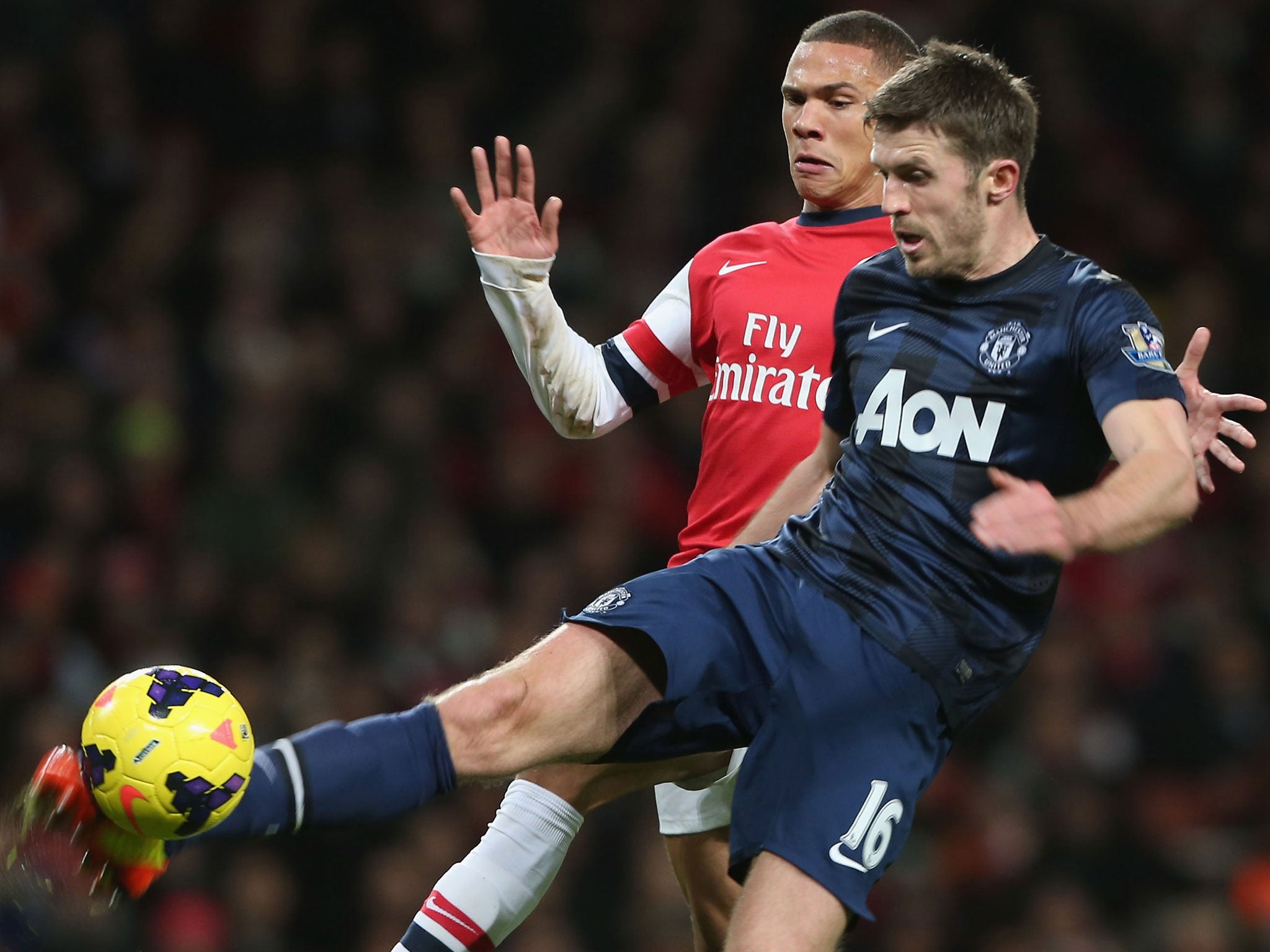 Michael Carrick wins the ball against Arsenal