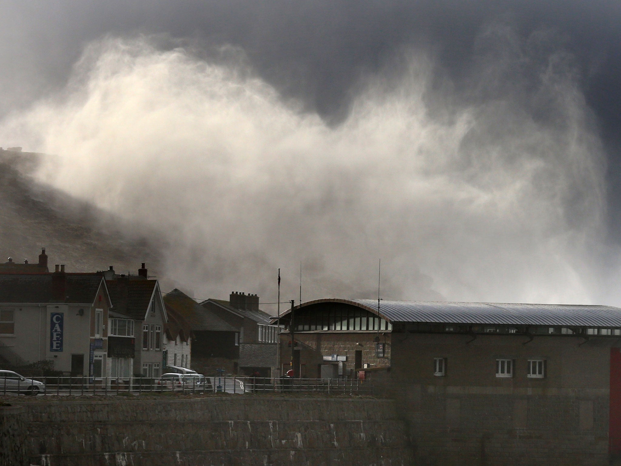 Storm waves crash over cliffs at Sennen Cove near Lands End on February 12, 2014 in Cornwall, England.