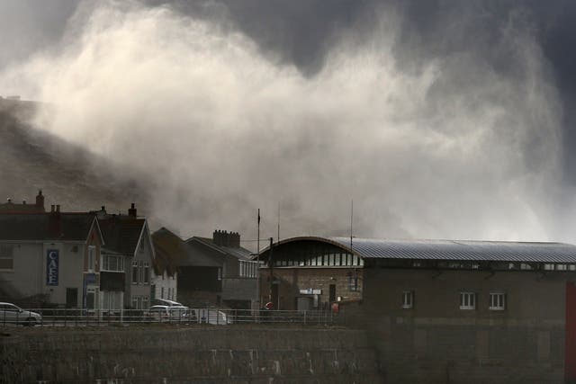 Storm waves crash over cliffs at Sennen Cove near Lands End on February 12, 2014 in Cornwall, England. 