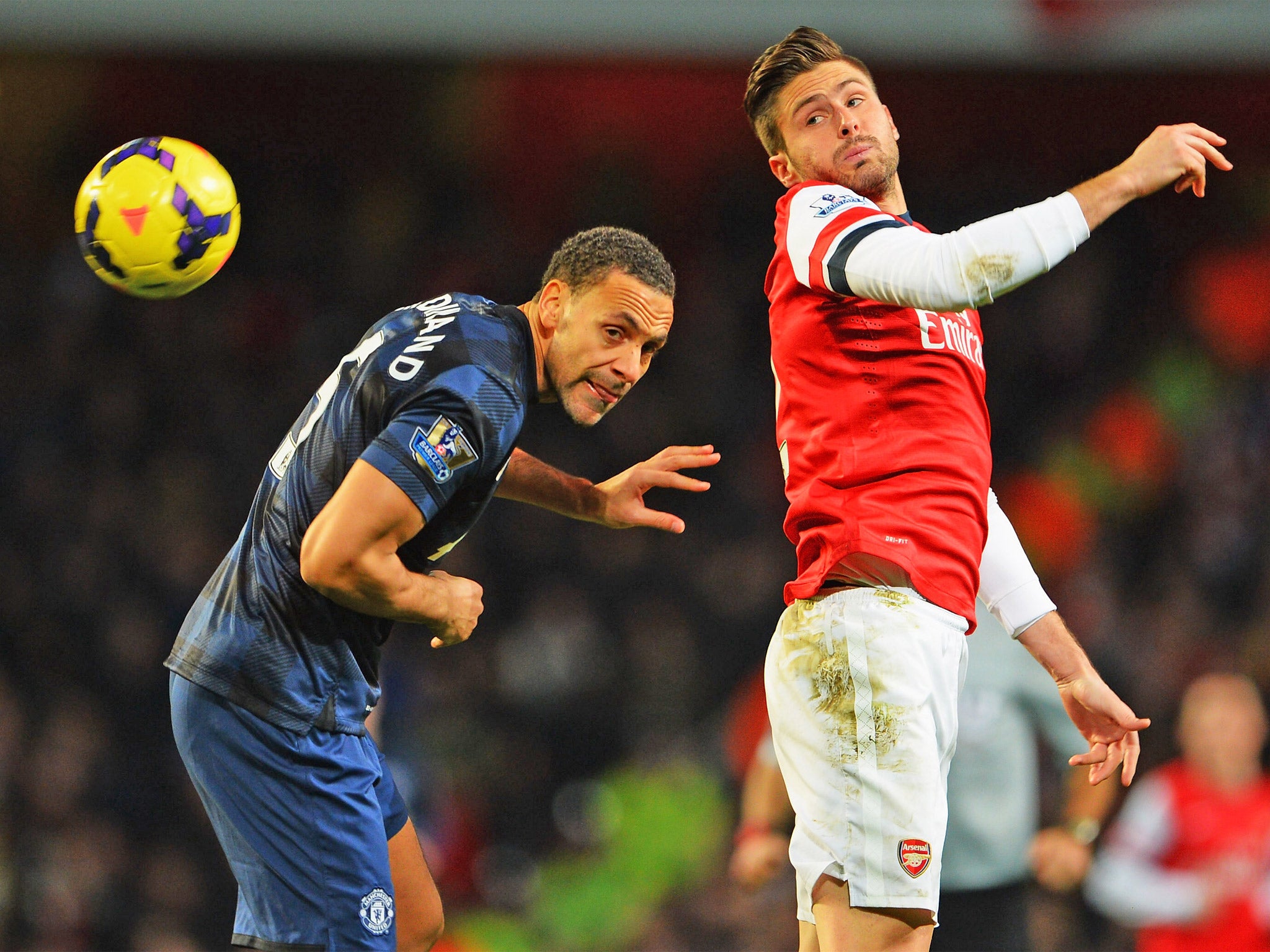 Oliver Giroud and Rio Ferdinand compete in the air