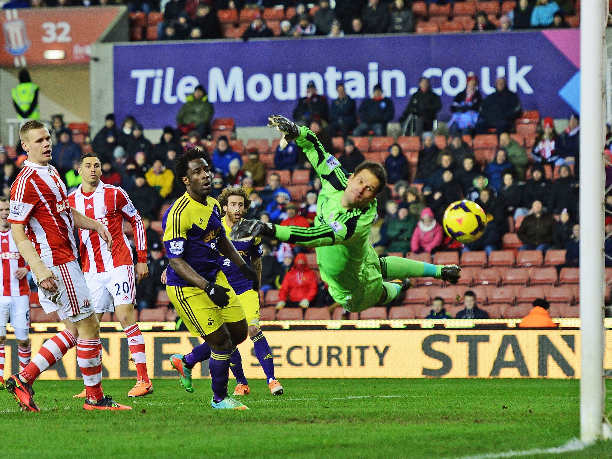Asmir Begovic dives but fails to save Chico Flores' effort from hitting the back of the net