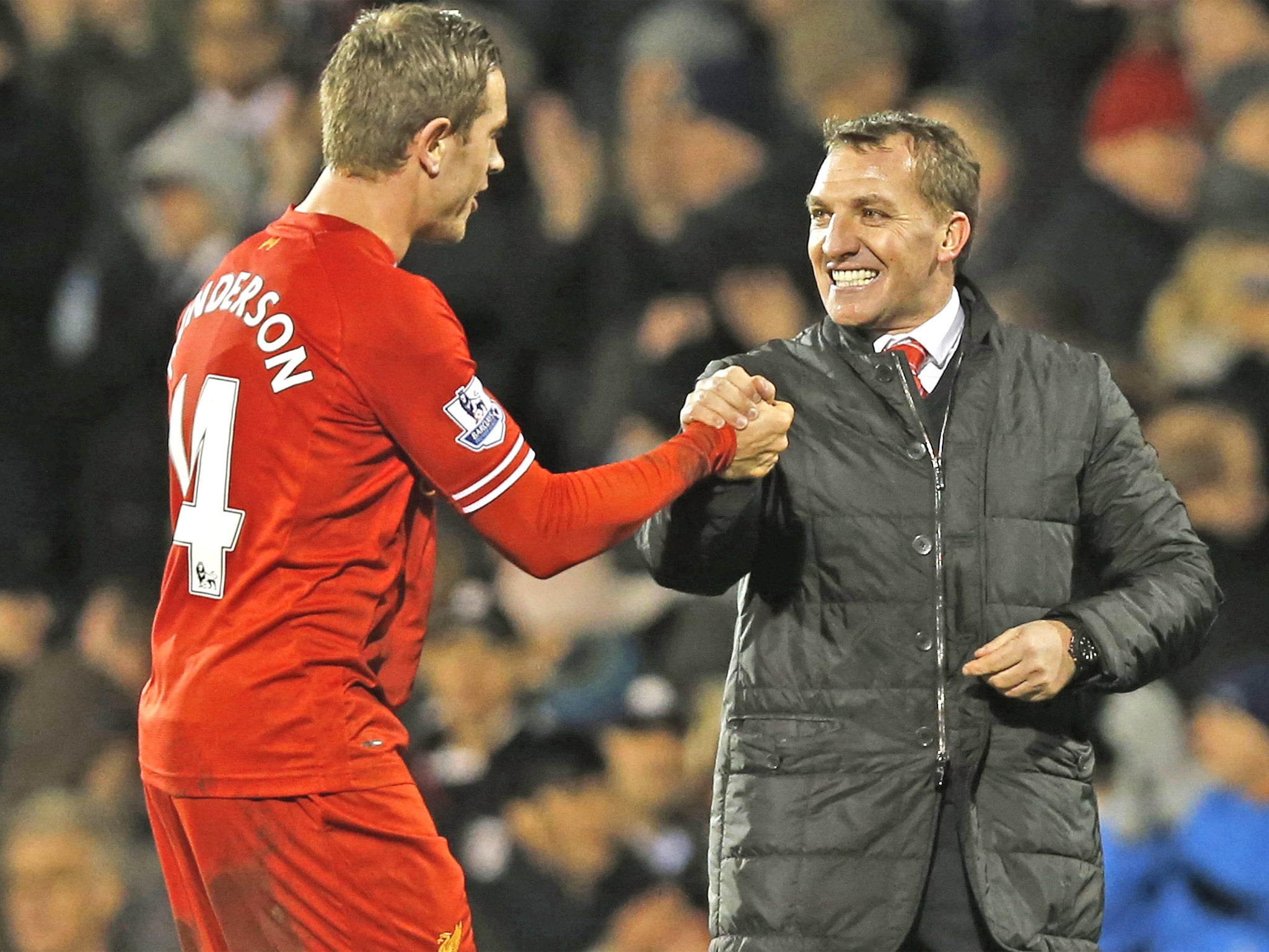 Liverpool manager Brendan Rodgers shares the joy of a hard-fought victory with midfielder Jordan Henderson