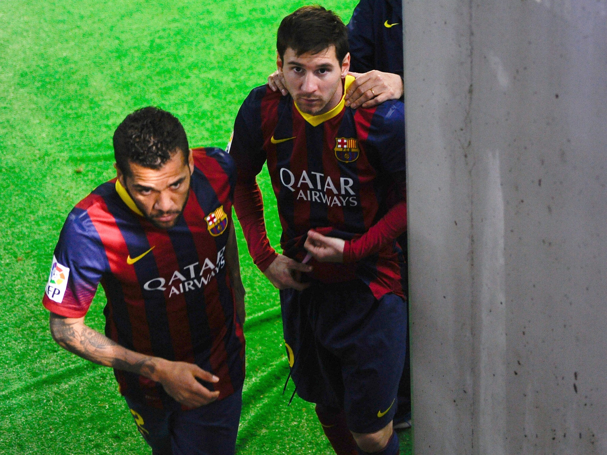 Lionel Messi and his teammate Dani Alves of FC Barcelona leave the locker room area prior to the Copa del Rey semi final second leg against Real Sociedad