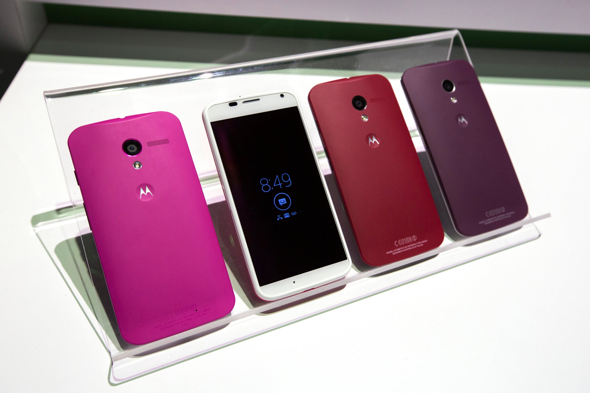 Different colored examples of Motorola's new Moto X phones rest on a table at a launch event in New York