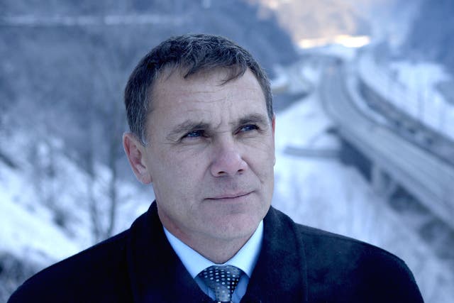 Environmental Watch ecology group activist Yevgeny Vitishko stands in front of the new road between Adler and Krasnaya Polyana in the Black Sea resort of Sochi