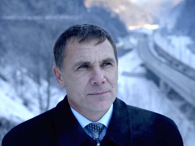 Environmental Watch ecology group activist Yevgeny Vitishko stands in front of the new road between Adler and Krasnaya Polyana in the Black Sea resort of Sochi