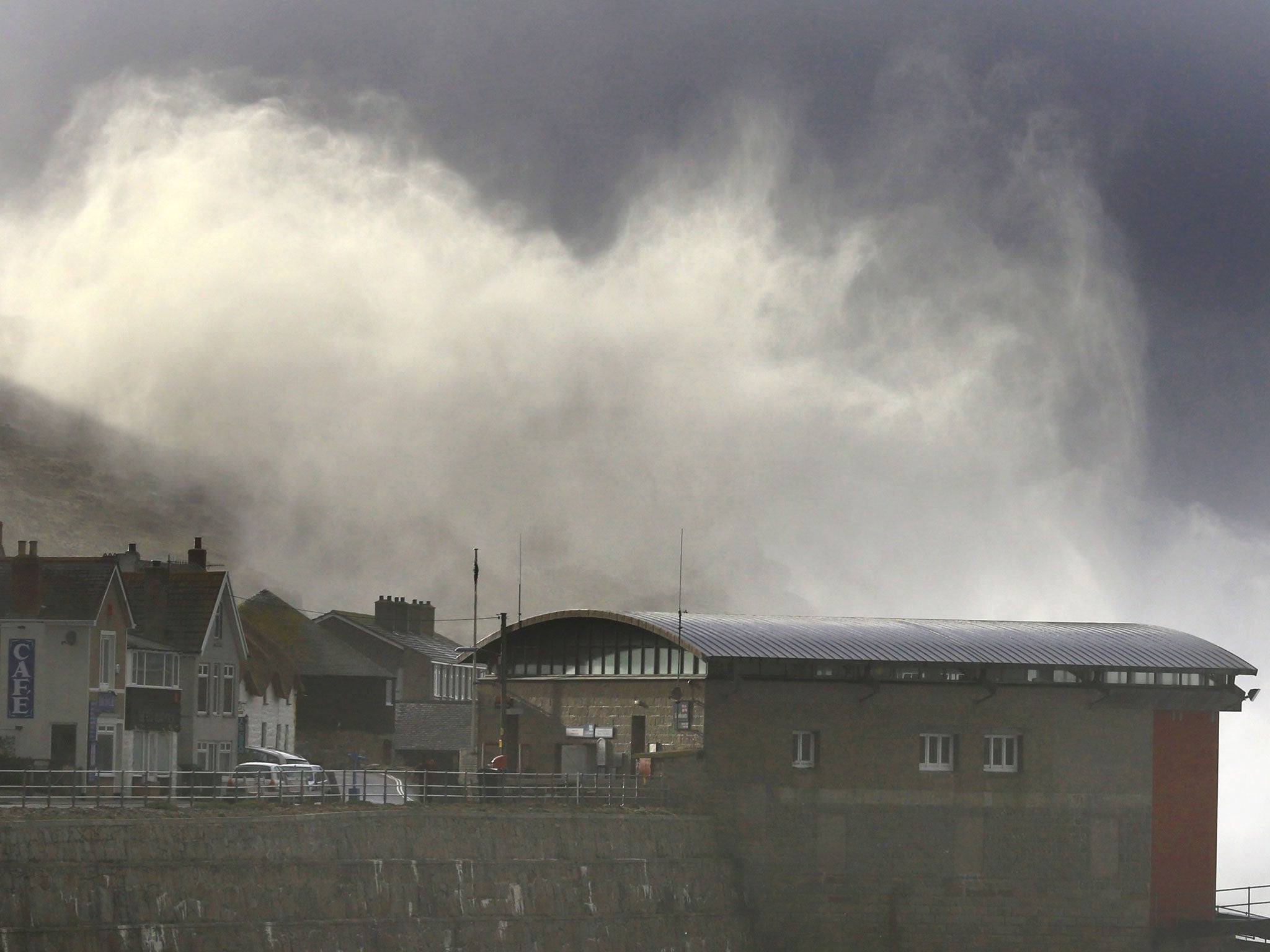 Storm waves crash over cliffs at Sennen Cove near Lands End in Cornwall