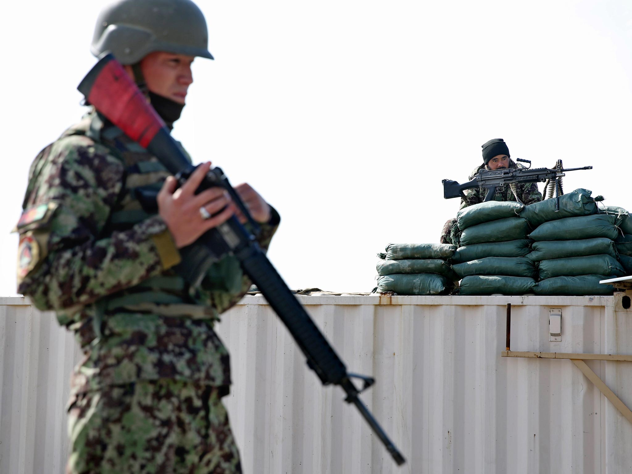 Afghan National Army soldiers guard near the main gate of the Parwan Detention Facility Center on the outskirts of Bagram