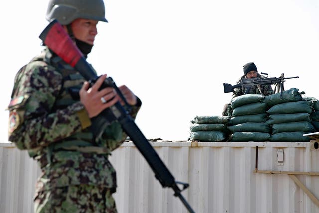 Afghan National Army soldiers guard near the main gate of the Parwan Detention Facility Center on the outskirts of Bagram