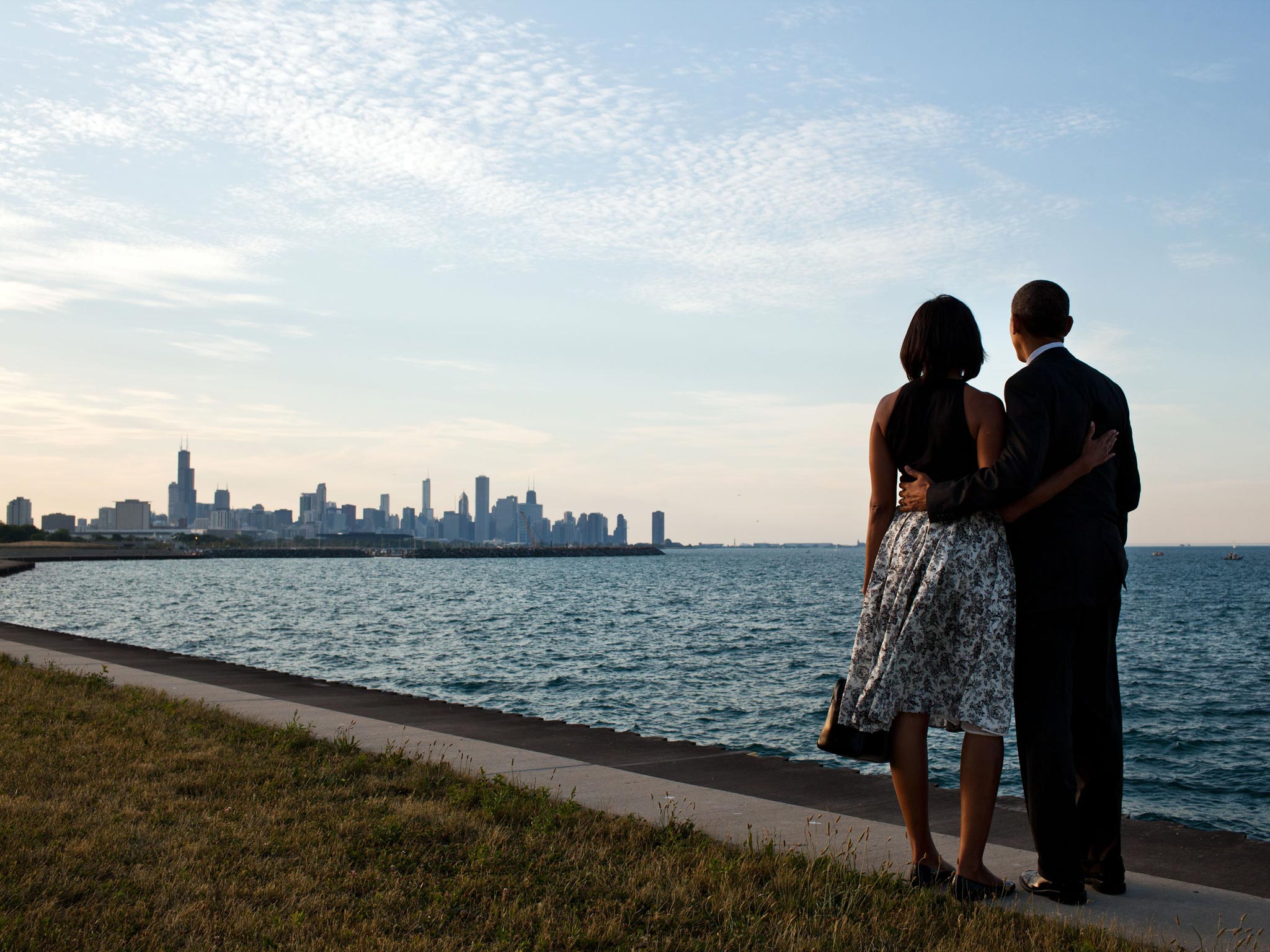 Barack and Michelle Obama stand on the edge of Lake Michigan to view the skyline of their home town Chicago