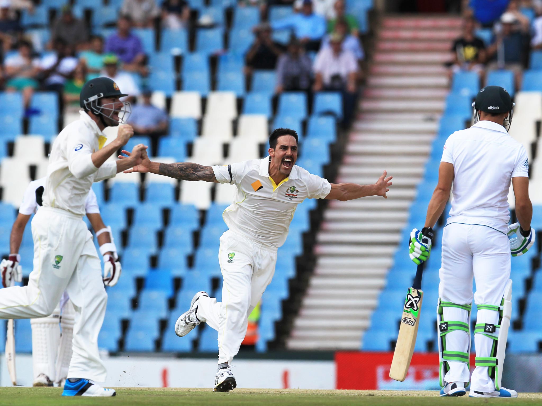 Mitchell Johnson celebrates taking the wicket of Faf du Plessis with a 93mph delivery