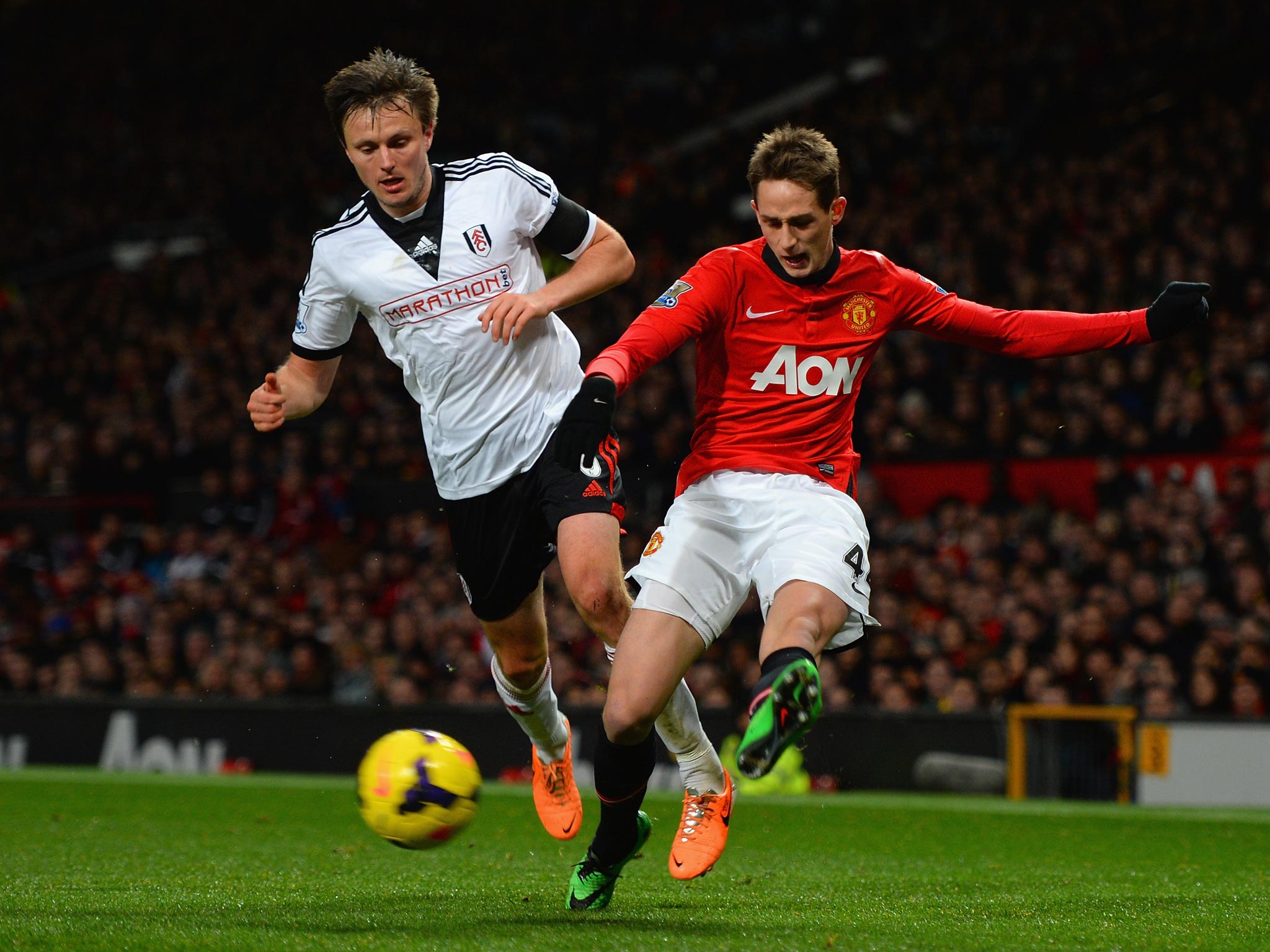 William Kvist of Fulham competes with Adnan Januzaj (right) of Manchester United