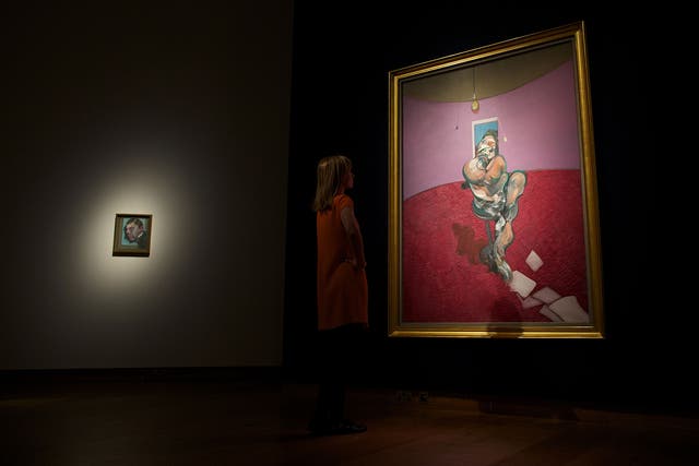 A Christie's employee looks at a work entitled 'Portrait of George Dyer Talking' by British artist Francis Bacon