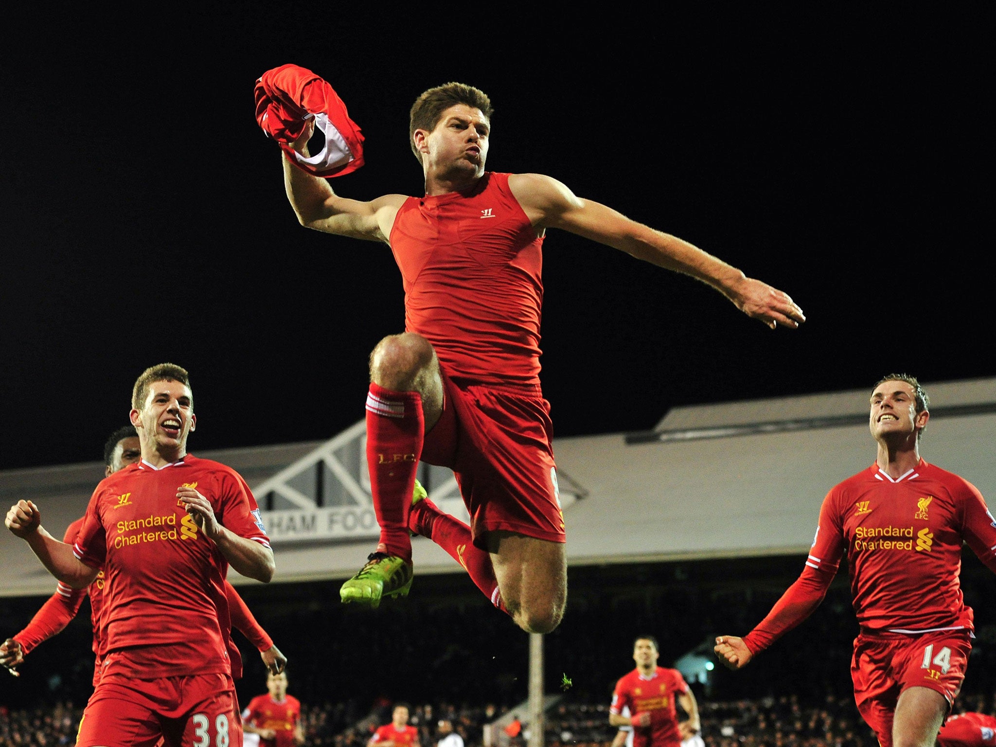 Liverpool's English midfielder Steven Gerrard (C) celebrates scoring their third goal during the English Premier League football match between Fulham and Liverpool at Craven Cottage in London