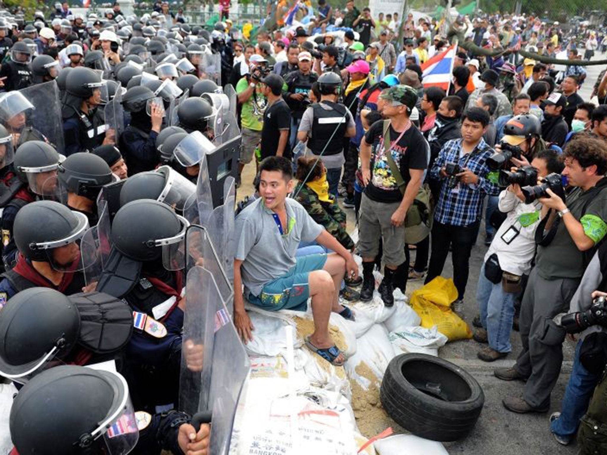 TOPSHOTS
Anti-government protesters are blocked by a group of police officers near the Government House building in Bangkok on 14 February 2014 (Getty)