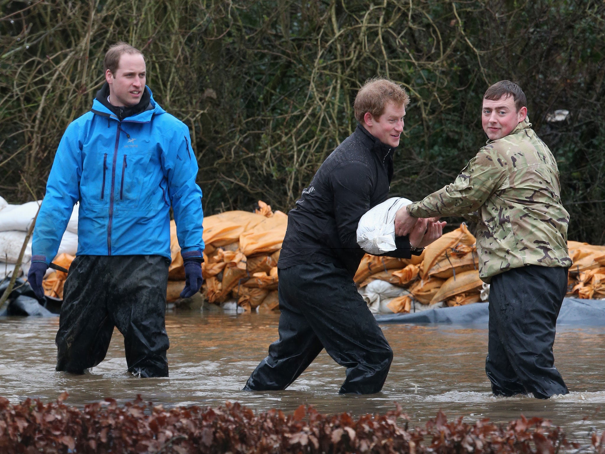 Prince William, Duke of Cambridge and Prince Harry help with flood defences around Eton End School in Datchet