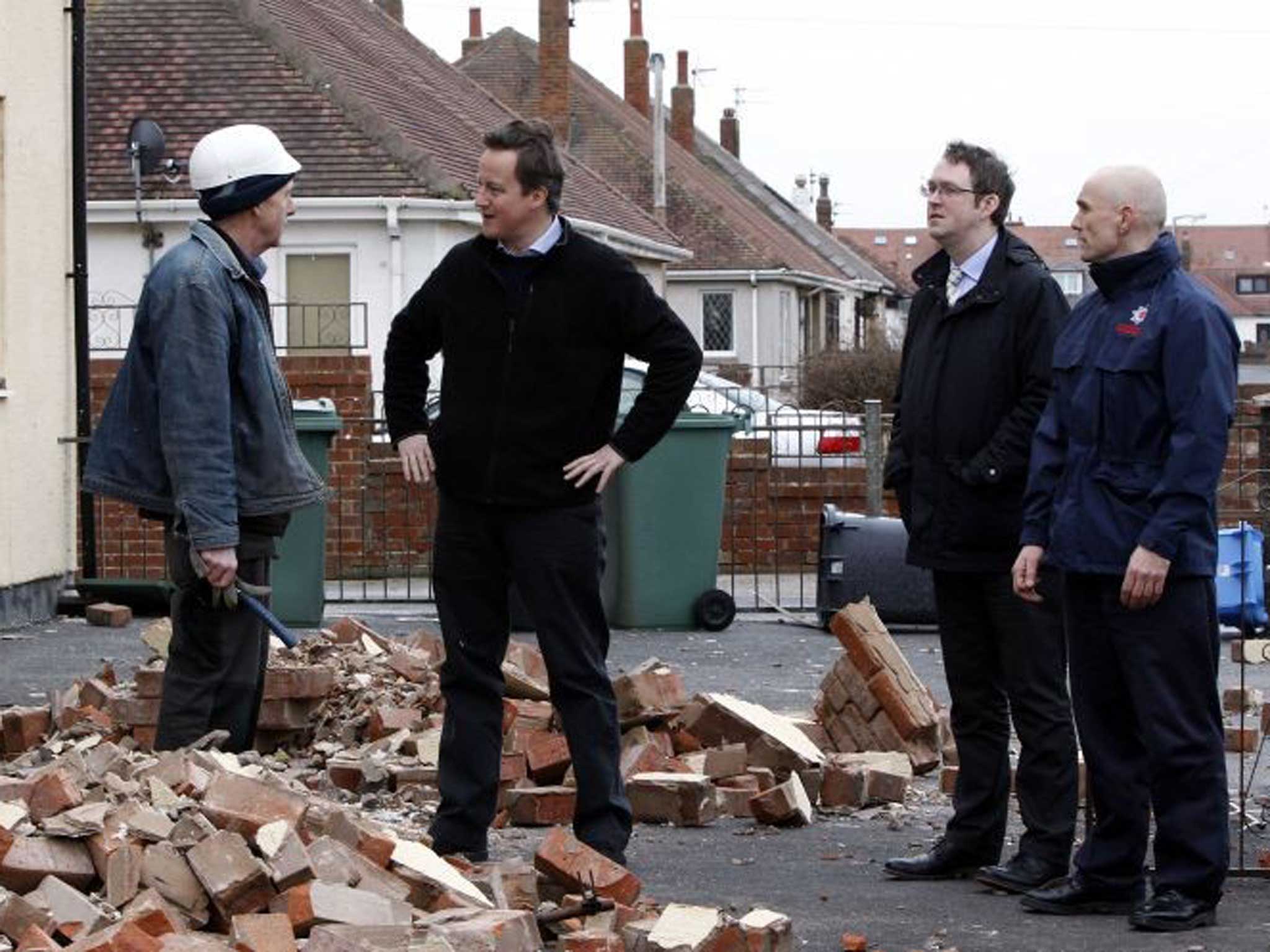 Talking to all: David Cameron speaks to a builder