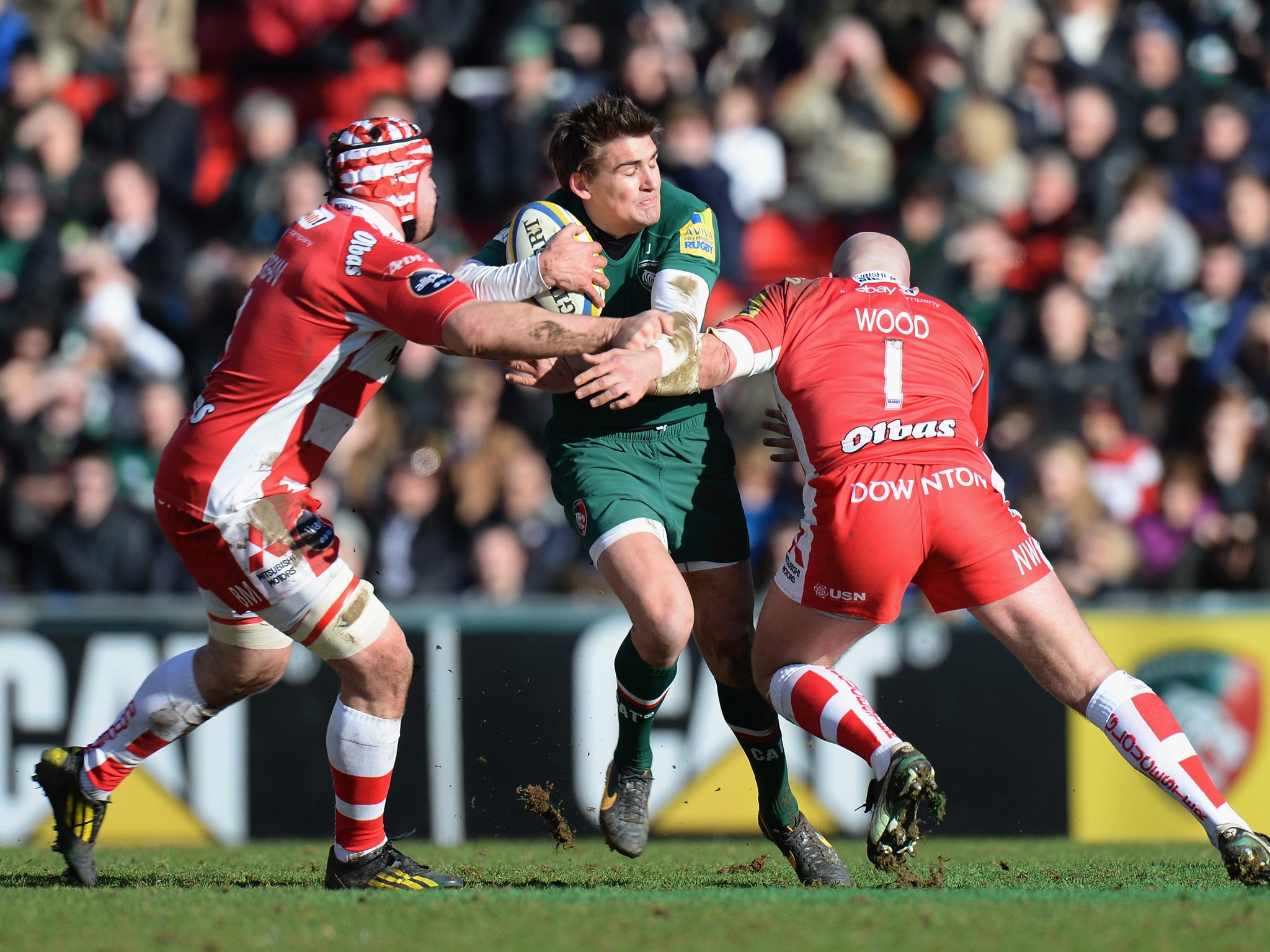 Toby Flood of Leicester Tigers tackled by Ben Morgan (left) and Nick Wood (right) of Gloucester