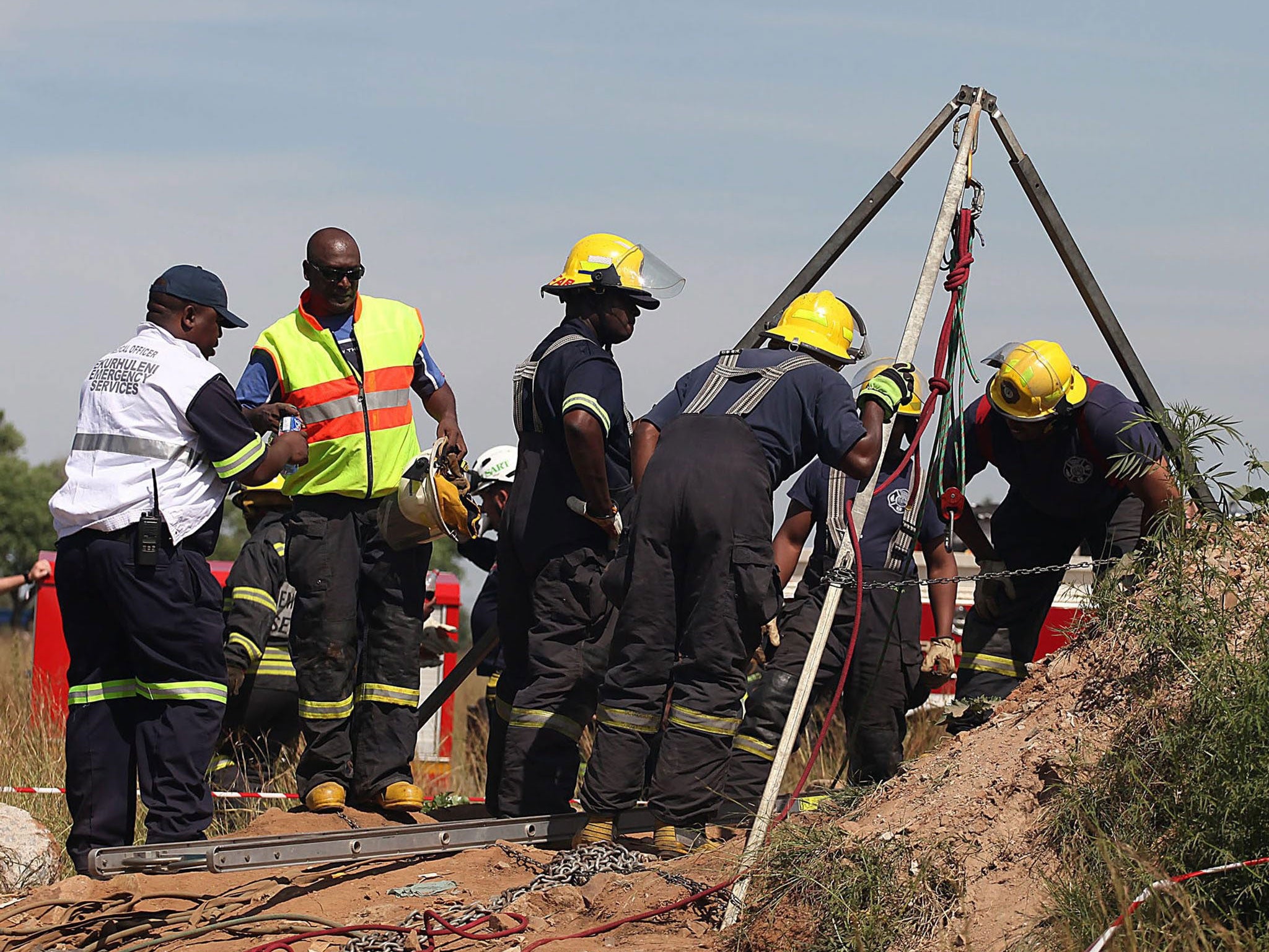Rescue services and emergency personnel try to free miners trapped underground in Benoni, east of Johannesburg, South Africa, 16 February 2014