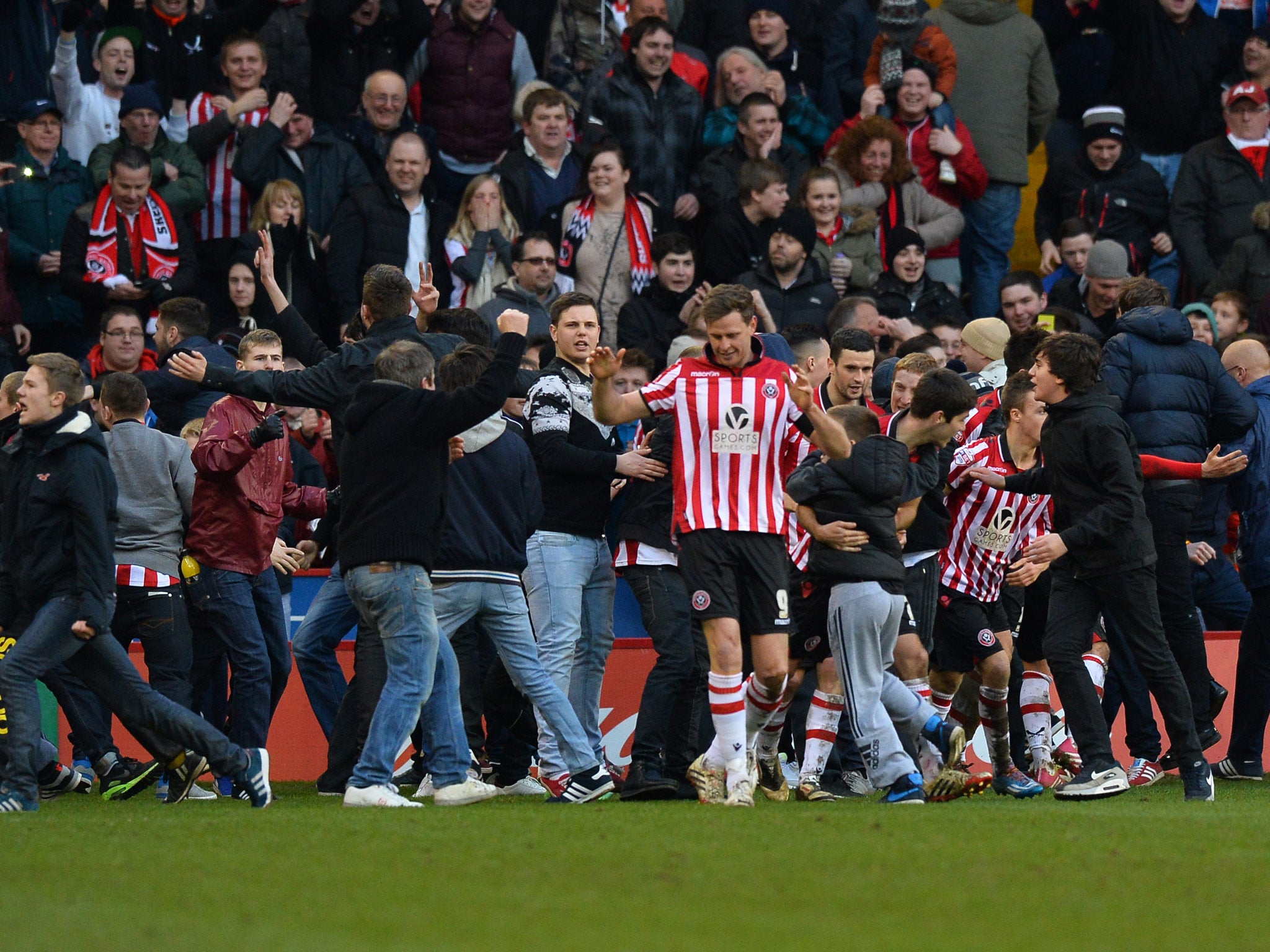 Sheffield United supporters invade the pitch after Sheffield United take a 3-1 lead over Nottingham Forest to reacg the FA Cup quarter-finals