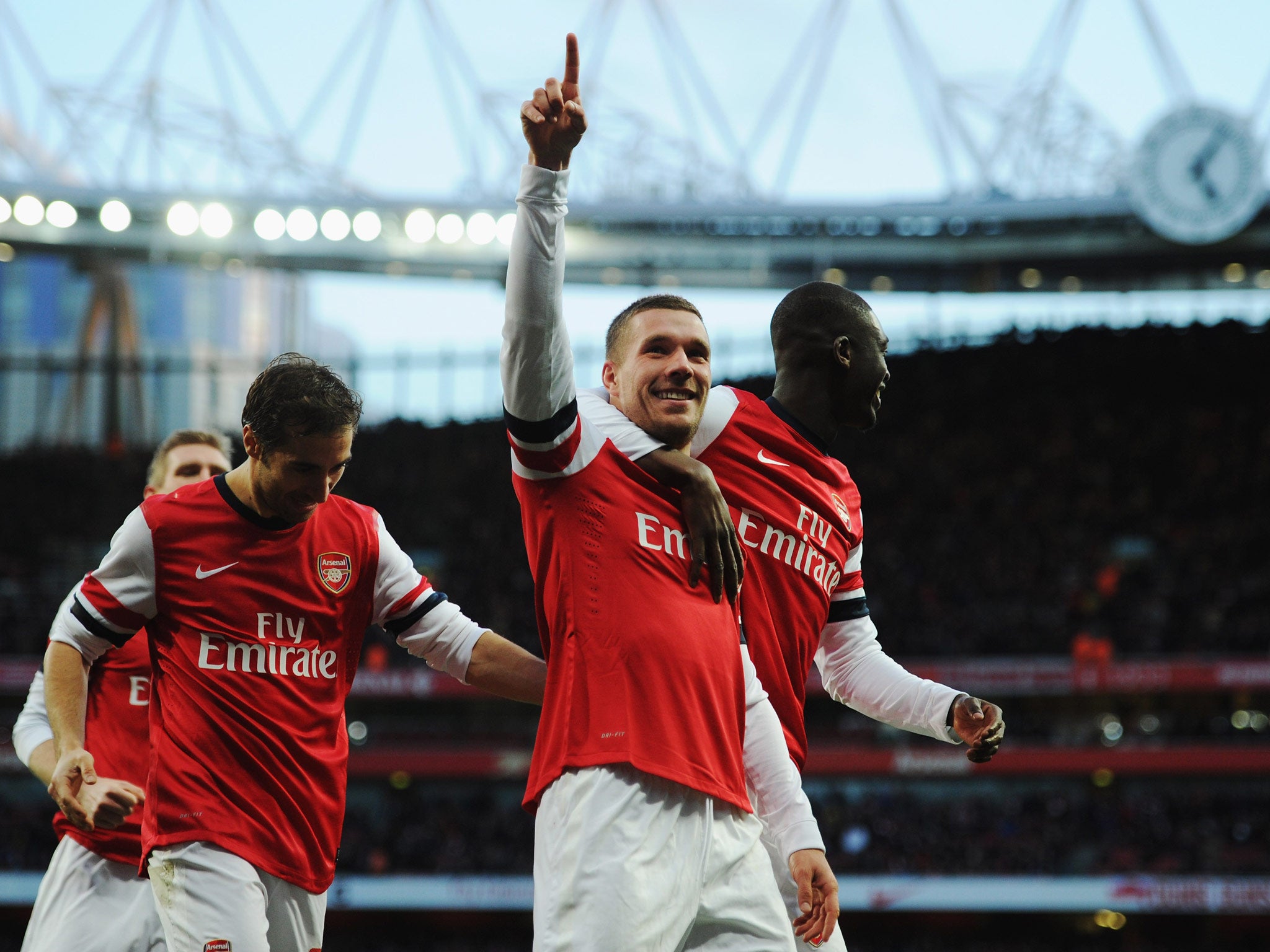 Luka Podolski celebrates after putting Arsenal 2-0 ahead against Liverpool in the FA Cup