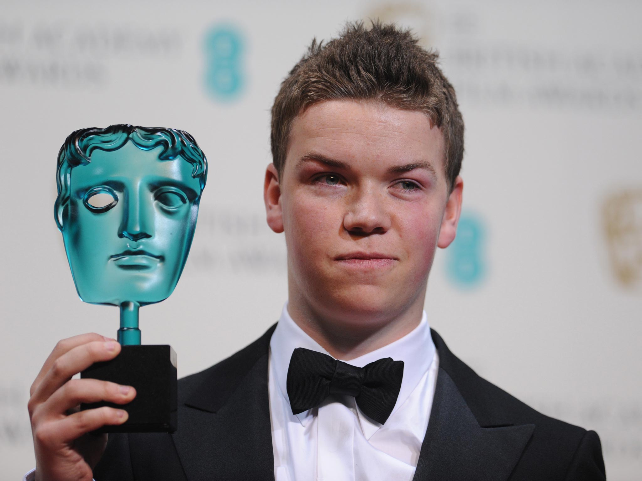 Will Poulter poses with the rising star award at the Baftas