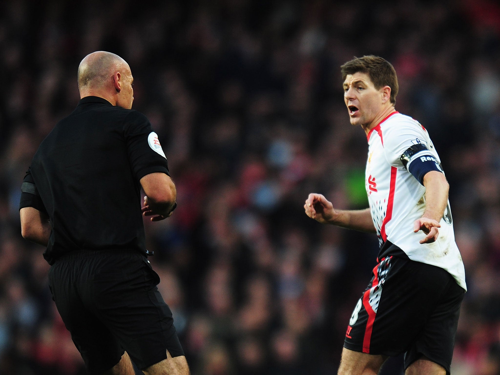 Steven Gerrard protests to referee Howard Webb over his failure to award a penalty for Alex Oxlade-Chamberlain's challenge on Luis Suarez