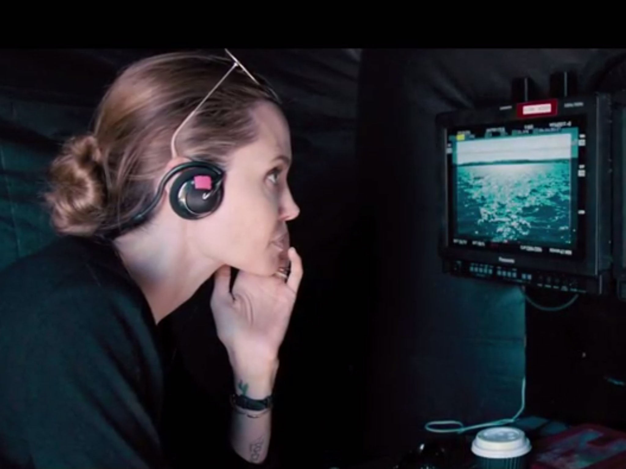 Angelina Jolie is seen in the director's chair in the first trailer for Unbroken