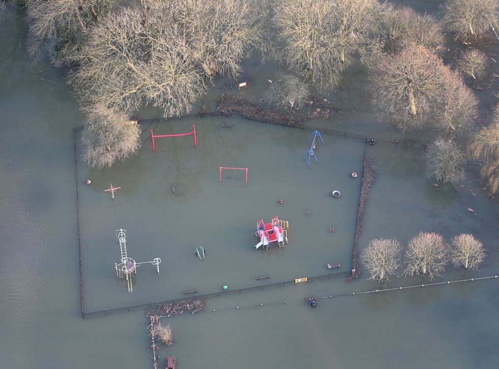 Flood water covers a children’s playground in Laleham