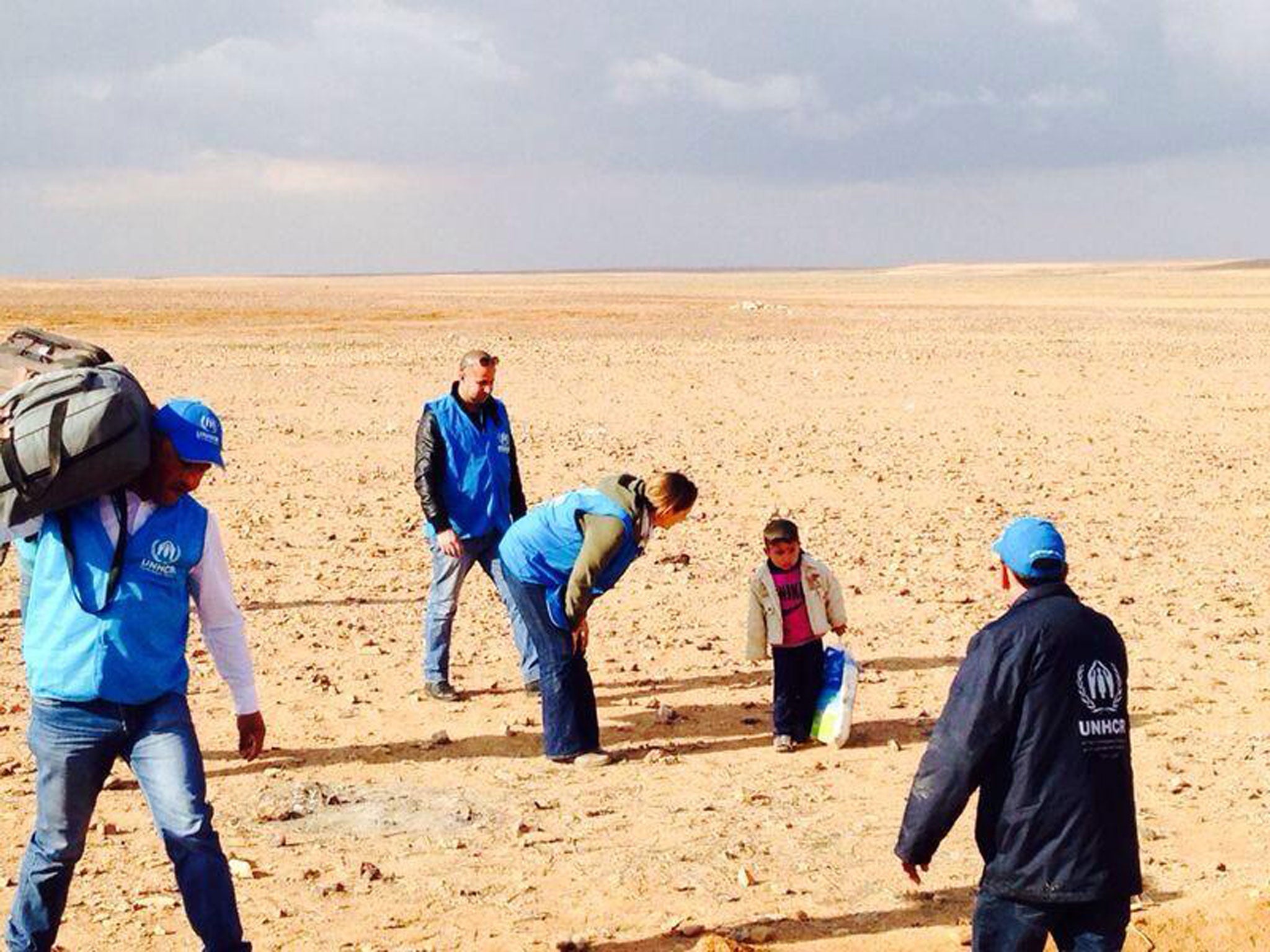 This extraordinary image showing four-year-old Syrian refugee Marwan being assisted by UNHCR officials was seized upon and shared around the world via social media