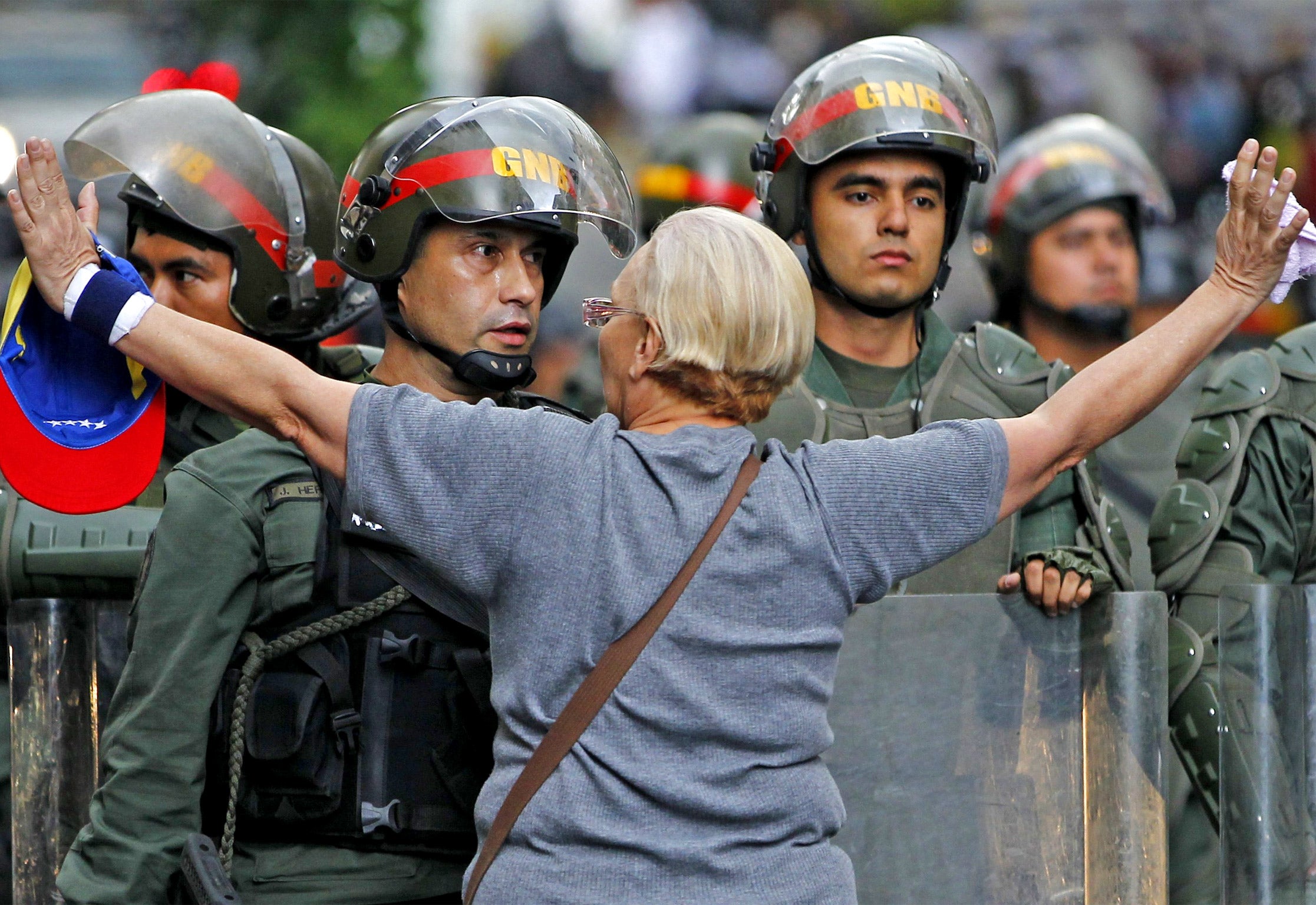 An opposition supporter shouts at a riot police officer during a protest against President Nicolas Maduro's government in Caracas