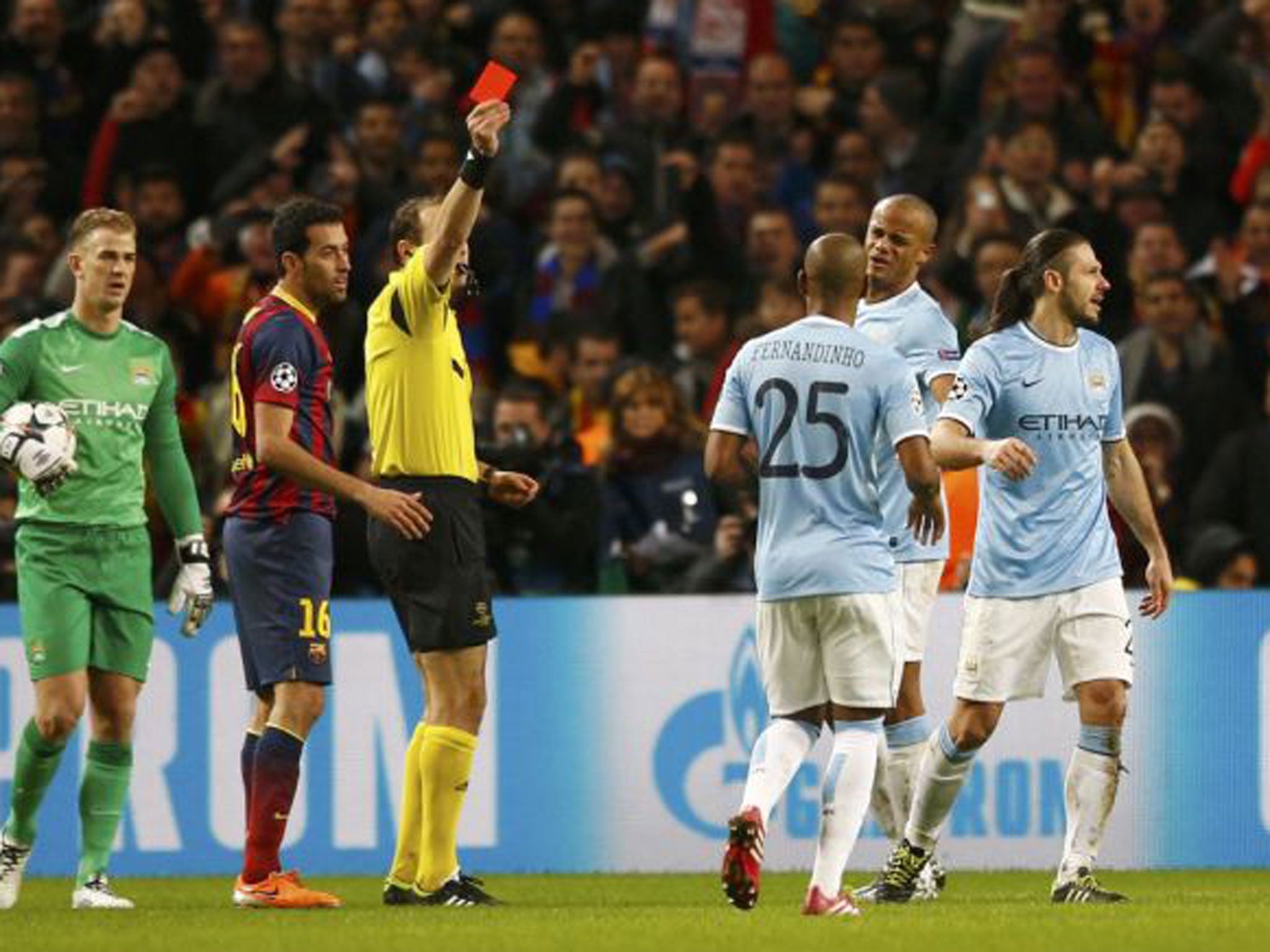 Martin Demichelis (right) is shown the red card