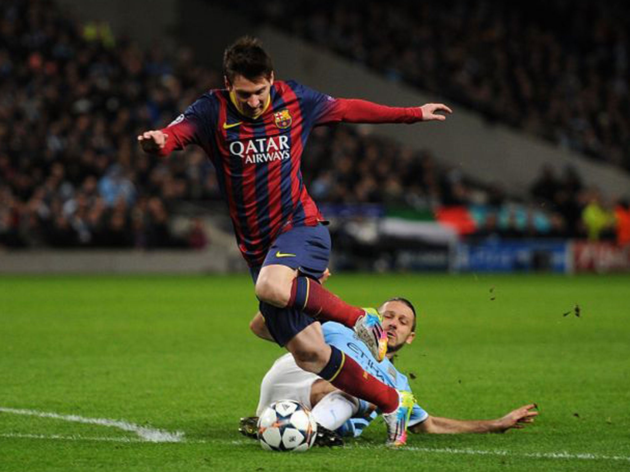 Manchester City's Martin Demichelis brings down Barcelona's Lionel Messi to concede a penalty and receives a red card