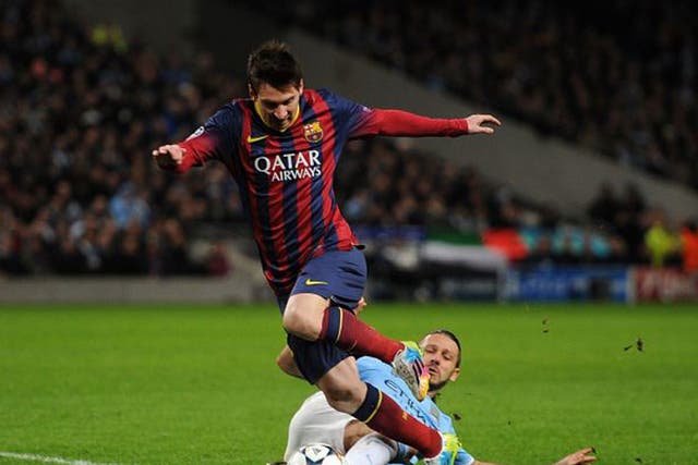 Manchester City's Martin Demichelis brings down Barcelona's Lionel Messi to concede a penalty and receives a red card