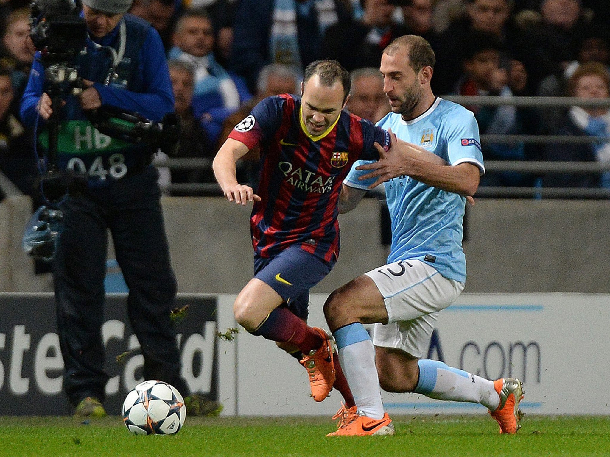 Andres Iniesta (left) is tackled by Manchester City's Pablo Zabaleta