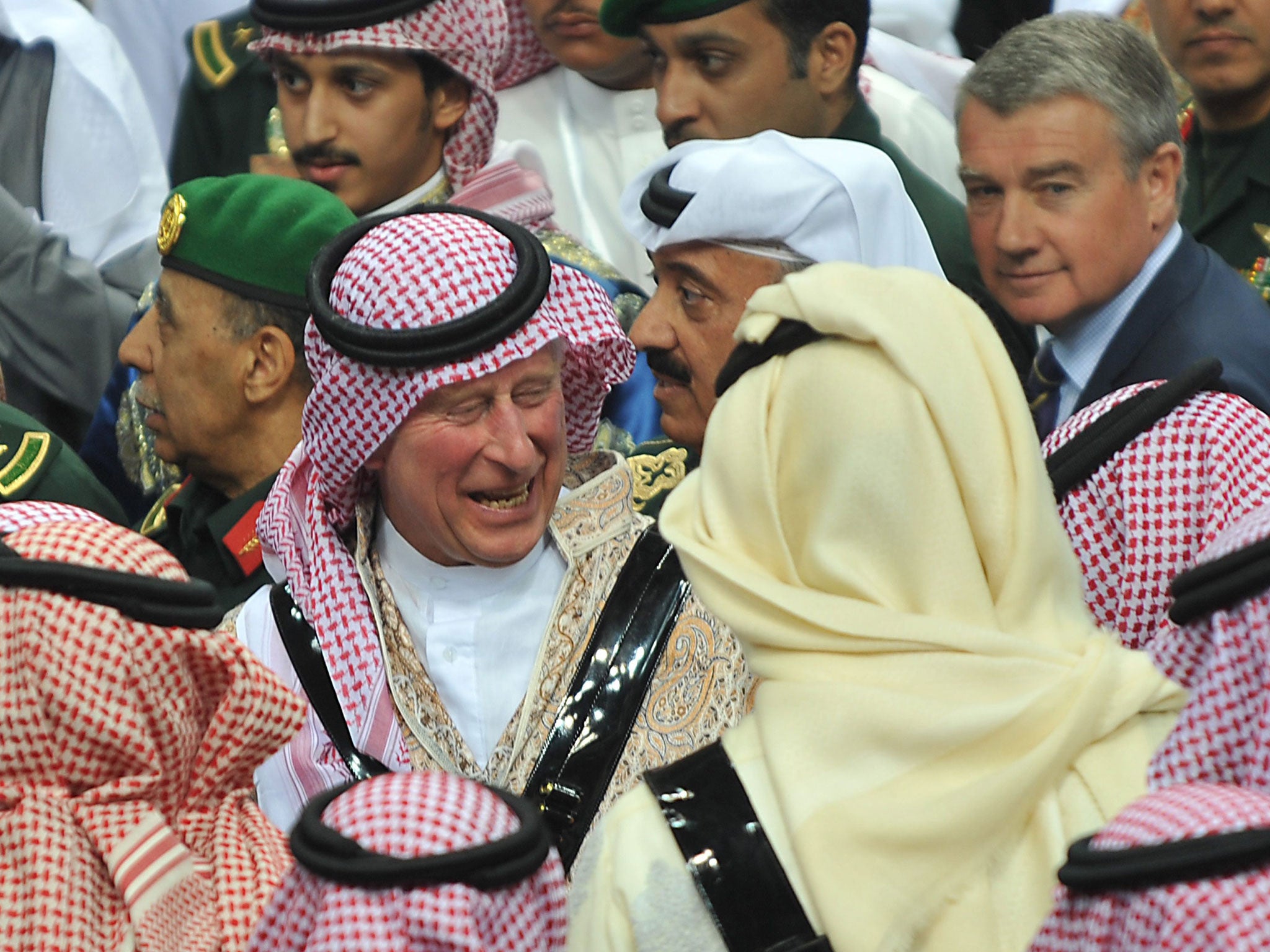 Prince Charles talks with unidentified Saudi Emirs after the end of traditional dancing on a tour last year