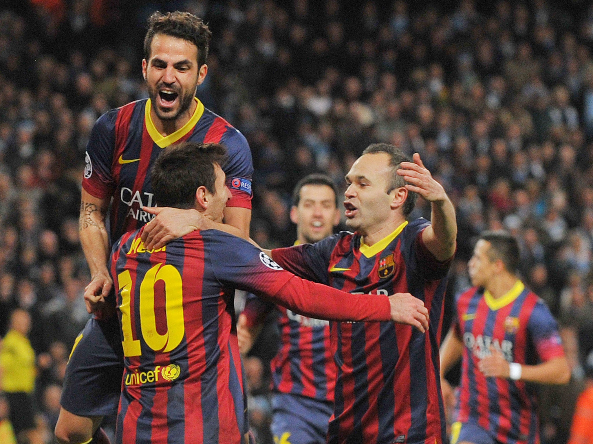 Cesc Fabregas and Andres Iniesta celebrate with Lionel Messi in their 2-0 win over Manchester City
