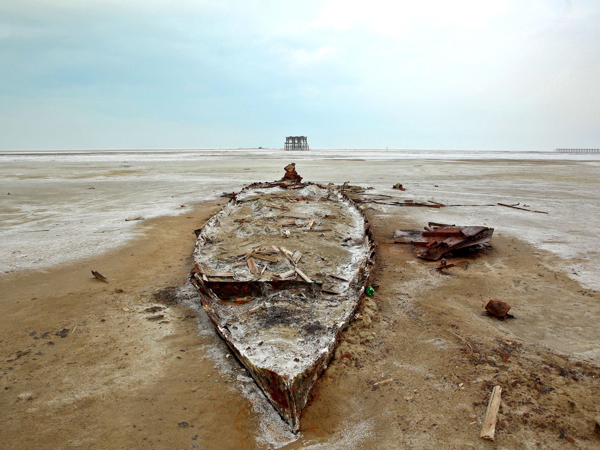 A wreckage of a boat is stuck in the solidified salts and sands at Lake Oroumieh