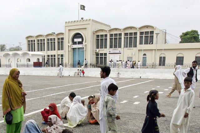 Pakistani visitors who come to see their jailed loved ones wait in the premises of Adiala Jail in Rawalpindi
