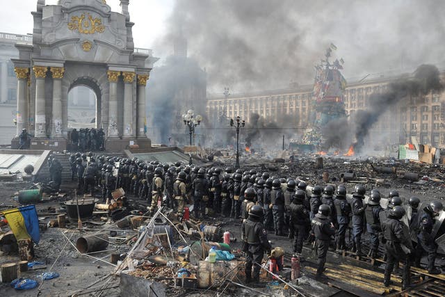 Riot police line up against anti-government protesters in Independence Square in central Kiev. More than 600 police and protesters have been injured 