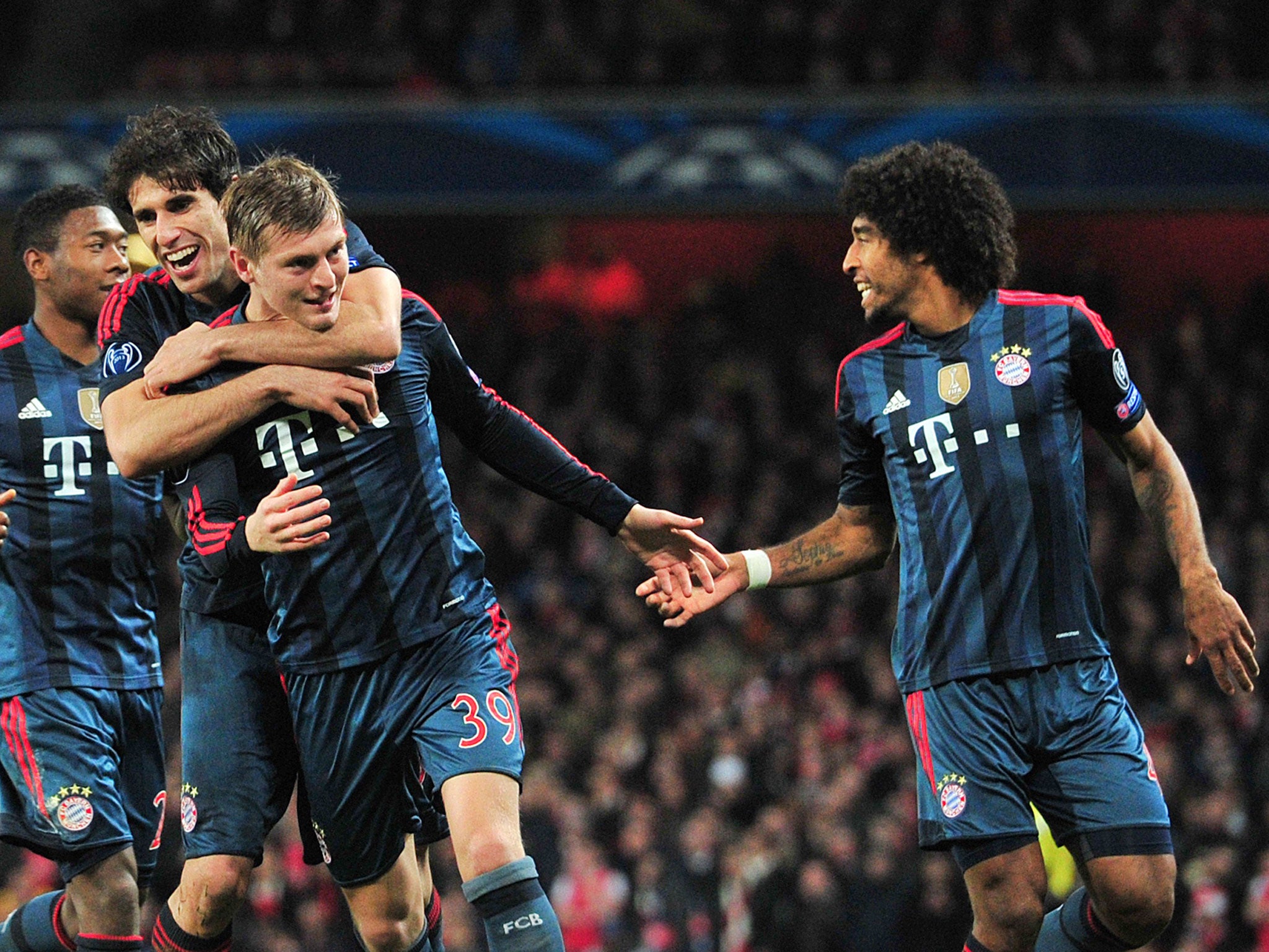 Bayern Munich team-mates congratulate Toni Kroos (No 39) on his opening goal against Arsenal