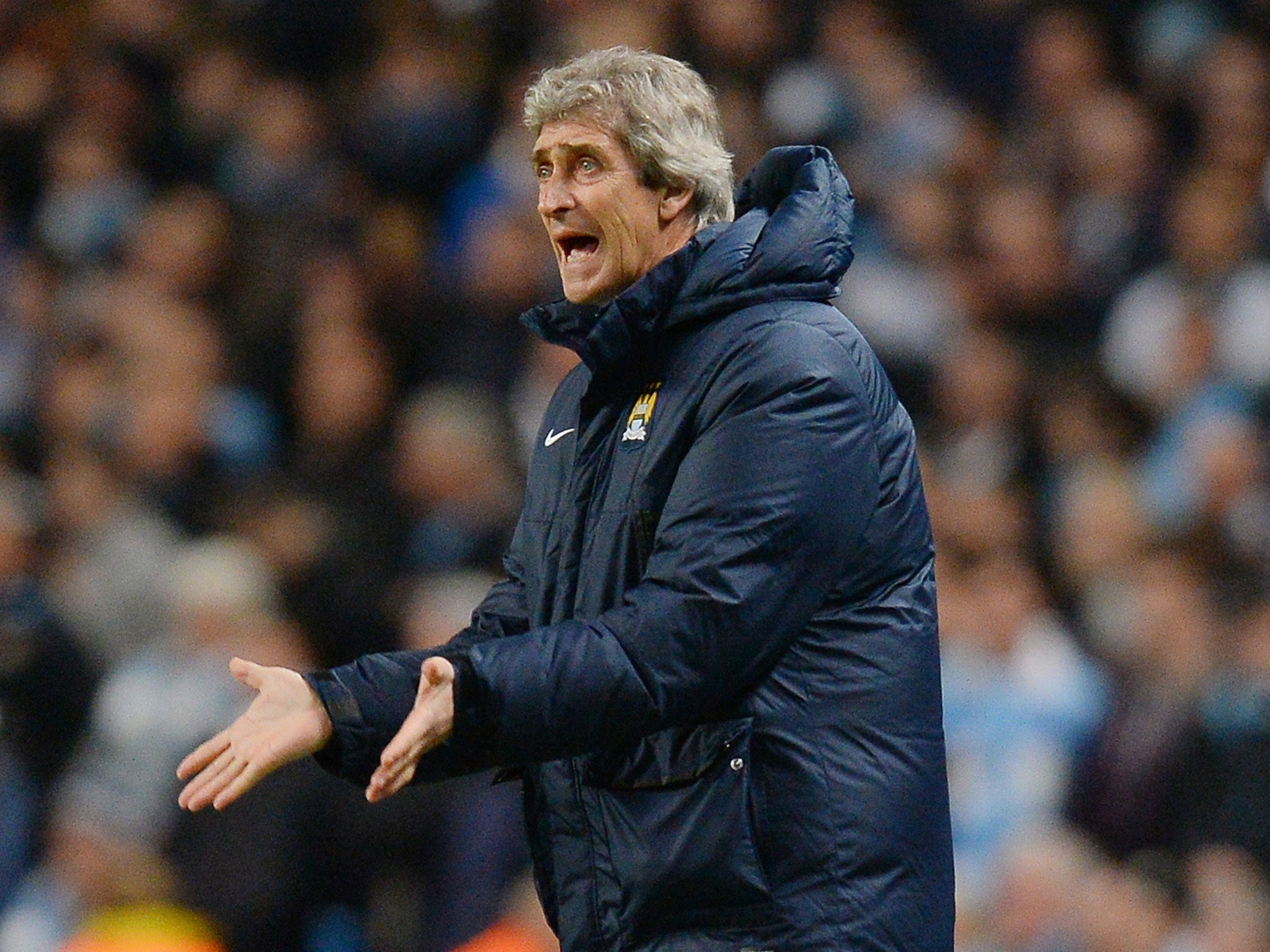 Manuel Pellegrini makes a gesture from the sideline