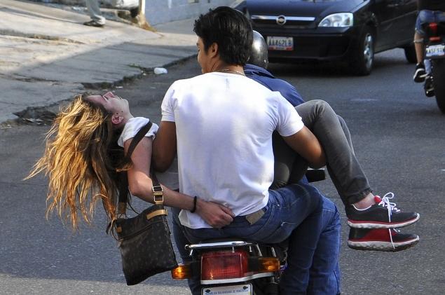 Genesis Carmona taken to hospital in a motorcycle in Valencia, Venezuela