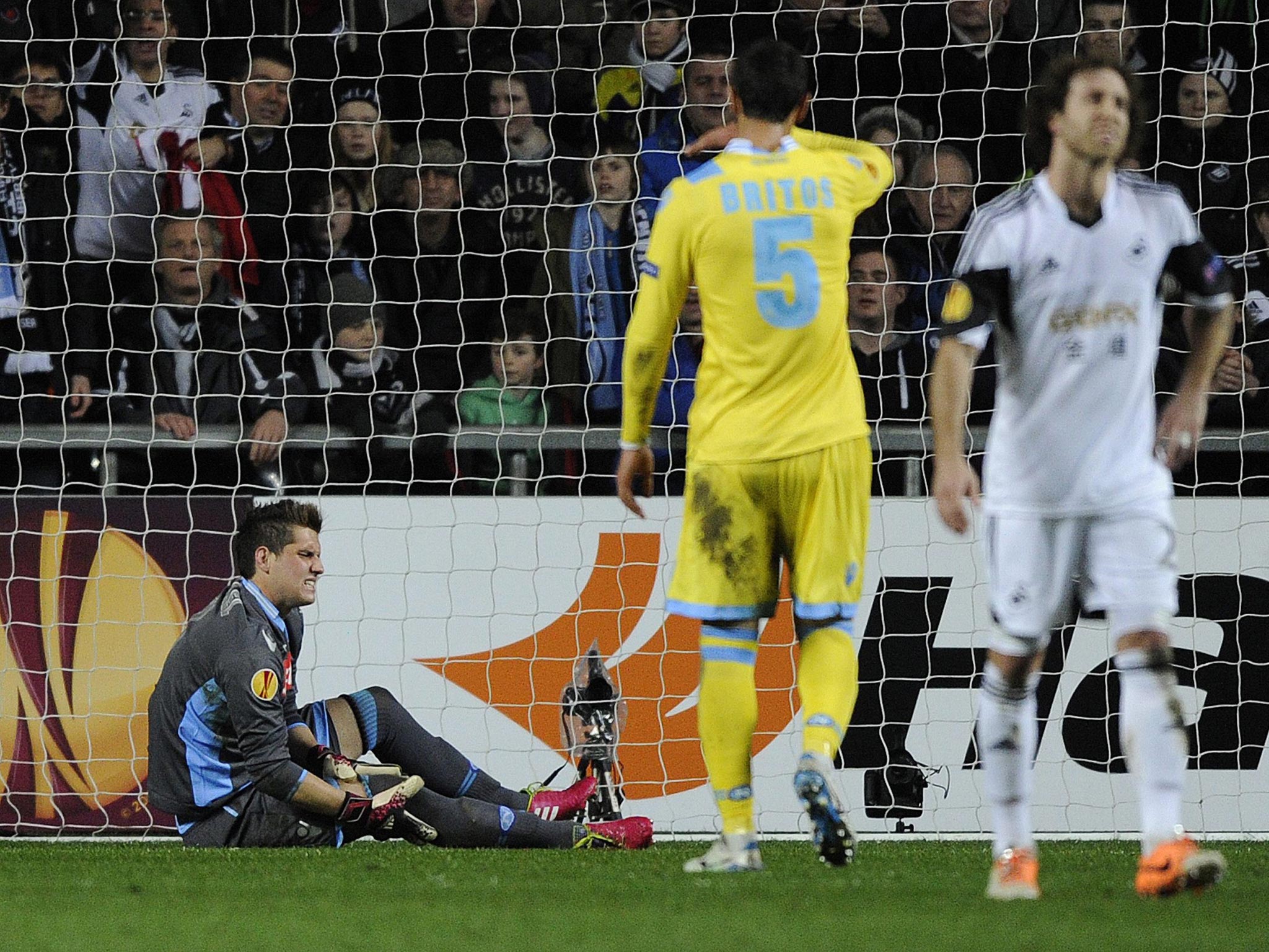 Napoli's goalkeeper Rafael Cabral (L) is injured during their Europa League soccer match against Swansea City at the Liberty Stadium in Swansea, Wales (Getty Images)